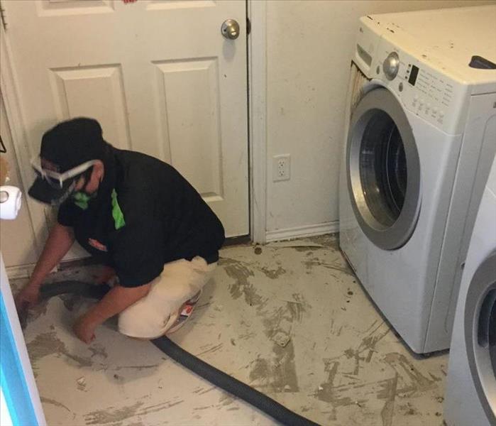 SERVPRO employee cleaning water damage