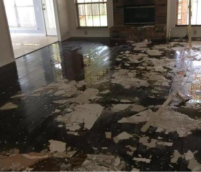 Floor of a home damaged by water, wet wooden floor.